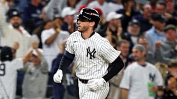 Oct 8, 2025; Bronx, New York, USA; New York Yankees third baseman Ryan McMahon (19) hits a solo home run during the third inning against the Toronto Blue Jays during game four of the ALDS round for the 2025 MLB playoffs at Yankee Stadium. Mandatory Credit: Vincent Carchietta-Imagn Images