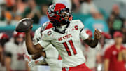Nov 15, 2025; Miami Gardens, Florida, USA; NC State Wolfpack quarterback CJ Bailey (11) throws downfield against the Miami Hurricanes during the third quarter at Hard Rock Stadium. Mandatory Credit: Sam Navarro-Imagn Images