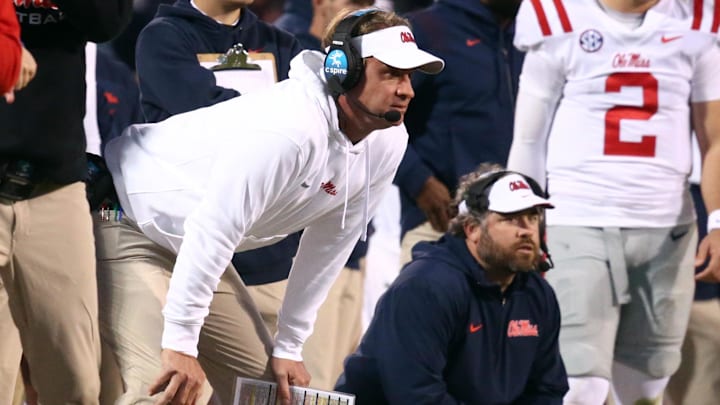 Nov 23, 2023; Starkville, Mississippi, USA; Mississippi Rebels head coach Lane Kiffin (left) and Mississippi Rebels defensive coordinator Pete Golding (right) watch during the second half against the Mississippi State Bulldogs at Davis Wade Stadium at Scott Field. Mandatory Credit: Petre Thomas-Imagn Images