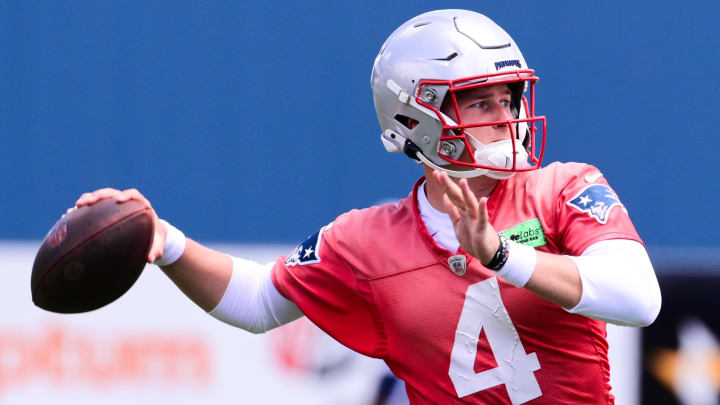 Jun 10, 2024; Foxborough, MA, USA; New England Patriots quarterback Bailey Zappe (4) throws a pass at minicamp at Gillette Stadium. Mandatory Credit: Eric Canha-USA TODAY Sports