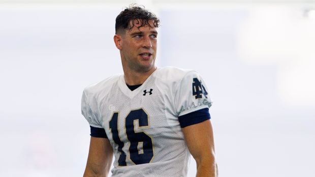 New Notre Dame punter James Rendell takes a break to watch other kickers during the first practice of fall camp 2024.