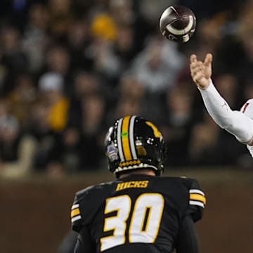 Nov 9, 2024; Columbia, Missouri, USA; Oklahoma Sooners wide receiver Jayden Gibson (1) throws a pass against Missouri Tigers linebacker Chuck Hicks (30) during the first half at Faurot Field at Memorial Stadium. Mandatory Credit: Jay Biggerstaff-Imagn Images