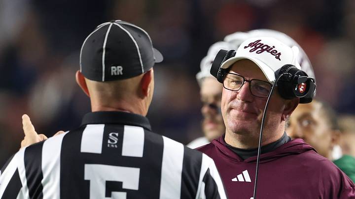 Nov 23, 2024; Auburn, Alabama, USA;  Texas A&M Aggies head coach Mike Elko speaks with a game official during the second quarter against the Auburn Tigers at Jordan-Hare Stadium. Mandatory Credit: John Reed-Imagn Images