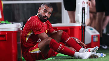 Jul 31, 2024; Philadelphia, PA, USA; Liverpool forward Mohamed Salah (11) removes his cleats after being subbed out during the second half against Arsenal at Lincoln Financial Field. Mandatory Credit: Bill Streicher-Imagn Images
