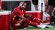 Jul 31, 2024; Philadelphia, PA, USA; Liverpool forward Mohamed Salah (11) removes his cleats after being subbed out during the second half against Arsenal at Lincoln Financial Field. Mandatory Credit: Bill Streicher-Imagn Images
