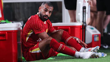 Jul 31, 2024; Philadelphia, PA, USA; Liverpool forward Mohamed Salah (11) removes his cleats after being subbed out during the second half against Arsenal at Lincoln Financial Field. Mandatory Credit: Bill Streicher-Imagn Images