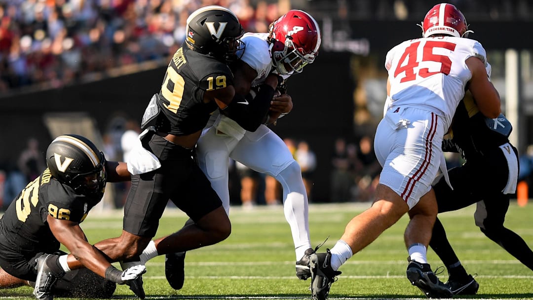 Alabama Crimson Tide quarterback Jalen Milroe (4) runs the ball as Vanderbilt Commodores safety De'Rickey Wright (19) 
