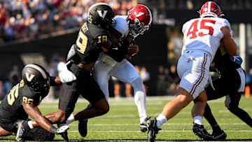 Alabama Crimson Tide quarterback Jalen Milroe (4) runs the ball as Vanderbilt Commodores safety De'Rickey Wright (19) 
