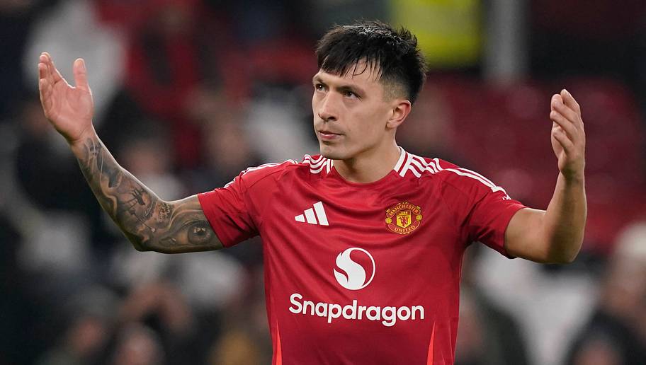 Lisandro Martinez in a Manchester United shirt with his arms raised during a match