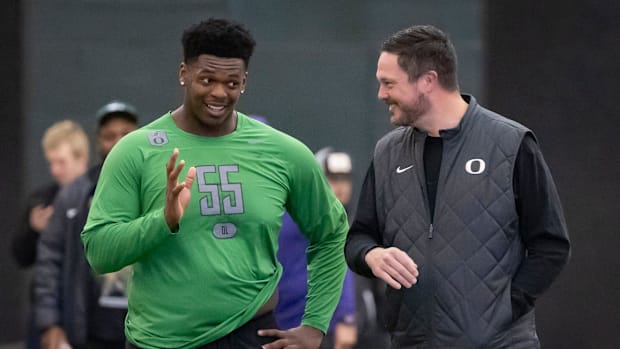 Oregon offensive lineman Marcus Harper II, left, talks to Oregon head coach Dan Lanning during the Oregon football’s Pro Day