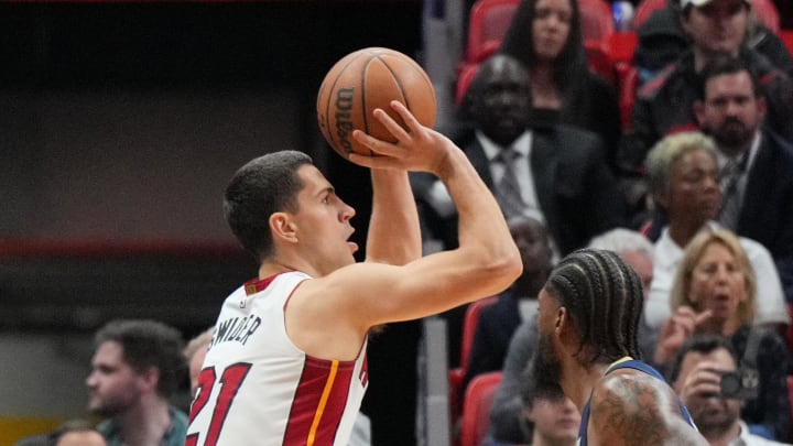 Mar 22, 2024; Miami, Florida, USA;  Miami Heat forward Cole Swider (21) attempts a three-point shot over New Orleans Pelicans forward Naji Marshall (8) during the first half at Kaseya Center. Mandatory Credit: Jim Rassol-USA TODAY Sports