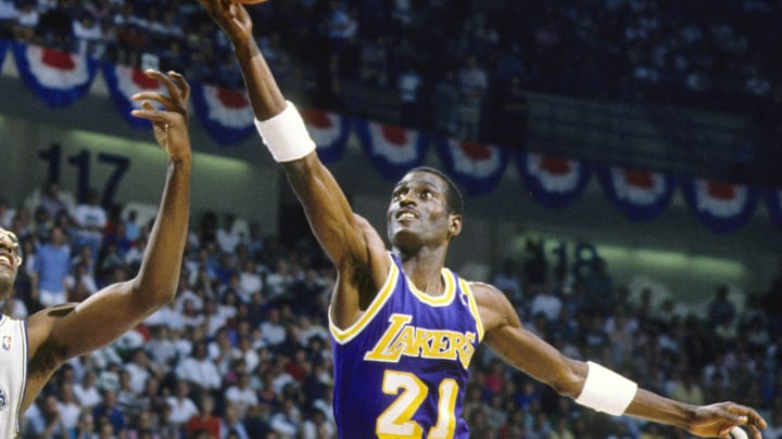 May 1988; Dallas, TX, USA; FILE PHOTO;  Los Angeles Lakers forward Michael Cooper (21) shoots over Dallas Mavericks forward Roy Tarpley (42) during the 1988 NBA Western Conference Finals at Reunion Arena. Mandatory Credit: MPS-USA TODAY Sports