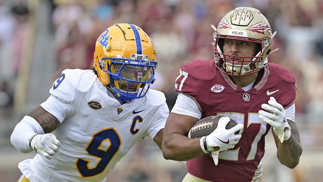 Florida State Seminoles running back Gavin Sawchuk (27) runs the ball past Pittsburgh Panthers linebacker Kyle Louis (9)