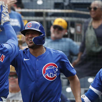 Aug 28, 2024; Pittsburgh, Pennsylvania, USA;  Chicago Cubs shortstop Dansby Swanson (7) and second baseman Luis Vazquez (12) celebrate after both players scored runs against the Pittsburgh Pirates during the ninth inning at PNC Park. Chicago won 14-10