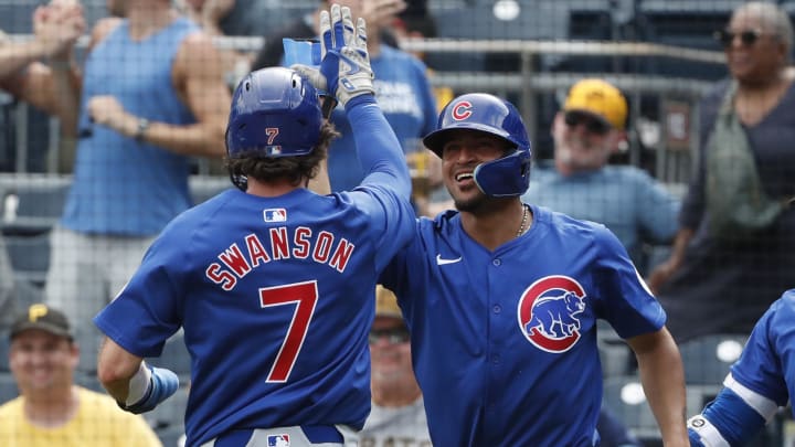 Aug 28, 2024; Pittsburgh, Pennsylvania, USA;  Chicago Cubs shortstop Dansby Swanson (7) and second baseman Luis Vazquez (12) celebrate after both players scored runs against the Pittsburgh Pirates during the ninth inning at PNC Park. Chicago won 14-10