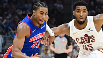 Oct 25, 2024; Cleveland, Ohio, USA; Detroit Pistons guard Jaden Ivey (23) drives to the basket against Cleveland Cavaliers guard Donovan Mitchell (45) during the first half at Rocket Mortgage FieldHouse. Mandatory Credit: Ken Blaze-Imagn Images