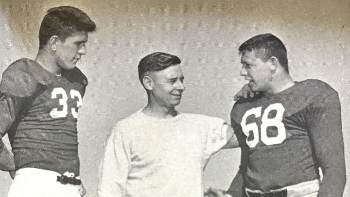 Indiana football coach Clyde Smith speaks with Joe and Walt Barkiewicz in a posed shot from the 1948 season.