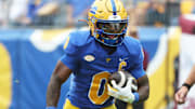 Sep 6, 2025; Pittsburgh, Pennsylvania, USA;  Pittsburgh Panthers running back Desmond Reid (0) carries the ball against the Central Michigan Chippewas during the first quarter at Acrisure Stadium. Mandatory Credit: Charles LeClaire-Imagn Images