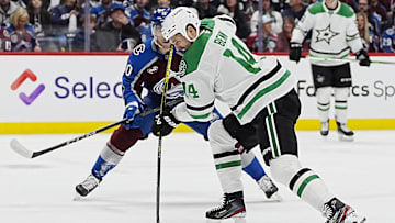 Mar 25, 2025; Denver, Colorado, USA; Dallas Stars left wing Jamie Benn (14) shoots the puck in the first period against the Colorado Avalanche at Ball Arena. Mandatory Credit: Ron Chenoy-Imagn Images