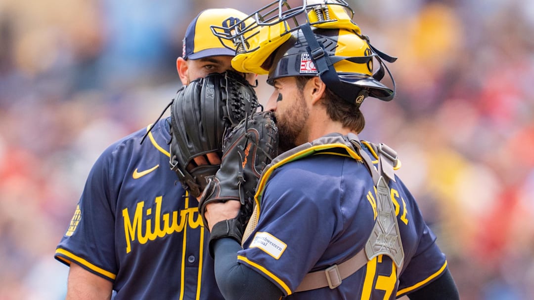 Jul 21, 2024; Minneapolis, Minnesota, USA; Milwaukee Brewers pitcher Aaron Civale (32) and Milwaukee Brewers catcher Eric Haase (13) discuss defensive strategy against the Minnesota Twins in the second inning at Target Field. Mandatory Credit: Matt Blewett-Imagn Images