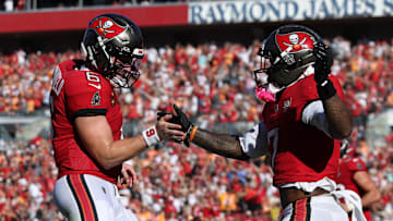 Tampa Bay Buccaneers running back Bucky Irving celebrates with quarterback Baker Mayfield 