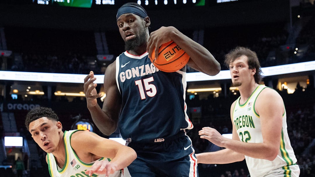 Oregon’s Jackson Shelstad, left, and Nate Bittle, right, battle Gonzaga’s Graham Ike for a rebound during the first half of the Northwest Elite Showdown at the Moda Center in Portland Dec. 21, 2025.