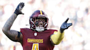 Nov 24, 2024; Landover, Maryland, USA; Washington Commanders linebacker Frankie Luvu (4) celebrates after making a play Dallas Cowboys during the second quarter at Northwest Stadium. Mandatory Credit: Geoff Burke-Imagn Images