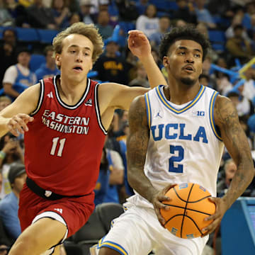 Nov 3, 2025; Los Angeles, California, USA;  UCLA Bruins guard Donovan Dent (2) drives to the basket between Eastern Washington Eagles guard Cole Scherer (11) and guard Alton Hamilton IV (4) during the second half at Pauley Pavilion presented by Wescom Financial. Mandatory Credit: Kiyoshi Mio-Imagn Images