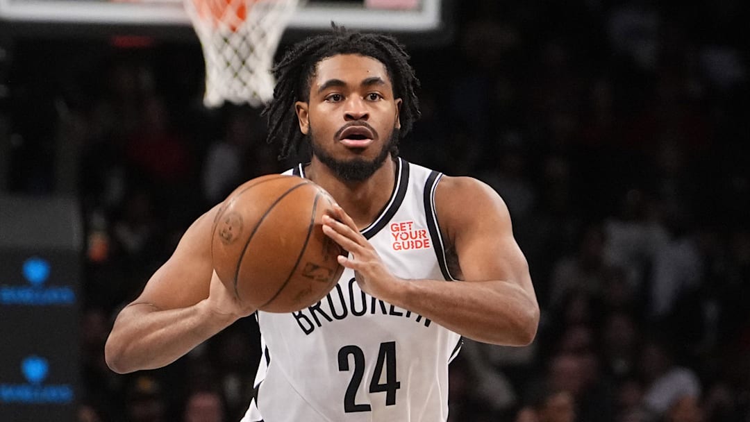 Oct 18, 2024; Brooklyn, New York, USA; Brooklyn Nets small guard Cam Thomas (24) passes the ball against Toronto Raptors point guard Davion Mitchell (45) during the first half at Barclays Center. Mandatory Credit: Gregory Fisher-Imagn Images