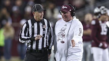 Nov 30, 2024; College Station, Texas, USA; Texas A&M Aggies head coach Mike Elko talks with an official during the second quarter against the Texas Longhorns at Kyle Field. Mandatory Credit: Troy Taormina-Imagn Images
