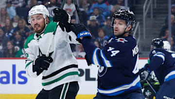 Mar 14, 2025; Winnipeg, Manitoba, CAN;  Winnipeg Jets defenseman Josh Morrissey (44) jostles for position with Dallas Stars forward Matt Duchene (95) during the first period at Canada Life Centre. Mandatory Credit: Terrence Lee-Imagn Images