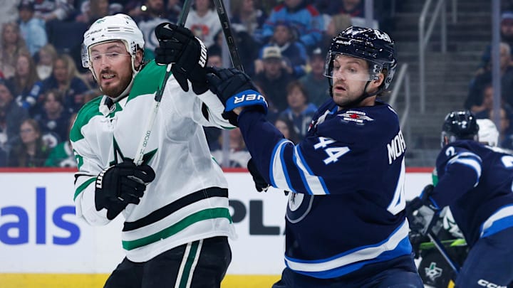 Mar 14, 2025; Winnipeg, Manitoba, CAN;  Winnipeg Jets defenseman Josh Morrissey (44) jostles for position with Dallas Stars forward Matt Duchene (95) during the first period at Canada Life Centre. Mandatory Credit: Terrence Lee-Imagn Images