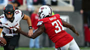 Oct 25, 2025; Lubbock, Texas, USA; Texas Tech Red Raiders defensive end David Bailey (31) pressures  Oklahoma State Cowboys quarterback Noah Walters (12) in the second half at Jones AT&T Stadium. Mandatory Credit: Michael C. Johnson-Imagn Images