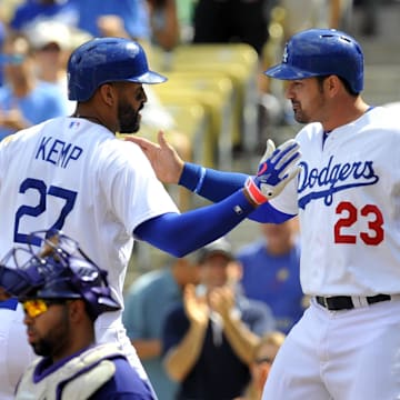 Los Angeles Dodgers left fielder Matt Kemp (27) and first baseman Adrian Gonzalez (23) celebrate after scoring runs in the first inning against the Colorado Rockies at Dodger Stadium. 