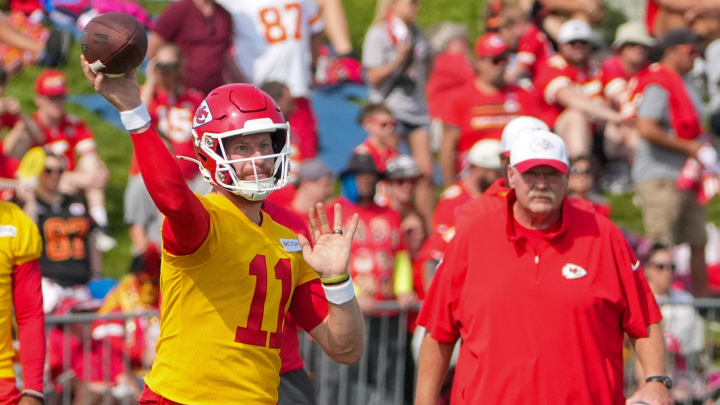 Jul 22, 2024; St. Joseph, MO, USA; Kansas City Chiefs quarterback Carson Wentz (11) throws a pass as head coach Andy Reid looks on during training camp at Missouri Western State University. Mandatory Credit: Denny Medley-USA TODAY Sports