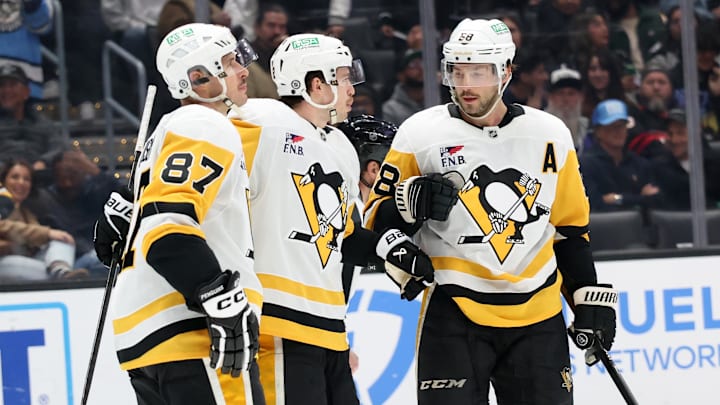 Jan 20, 2025; Los Angeles, California, USA;  Pittsburgh Penguins left wing Anthony Beauvillier (72, center) celebrates with center Sidney Crosby (87) and defenseman Kris Letang (58) after scoring a goal during the third period at Crypto.com Arena.