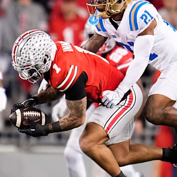 Ohio State Buckeyes wide receiver Brandon Inniss (1) catches a ball in front of UCLA Bruins defensive back Cole Martin (21) during the NCAA football game at Ohio Stadium in Columbus on Nov. 15, 2025.
