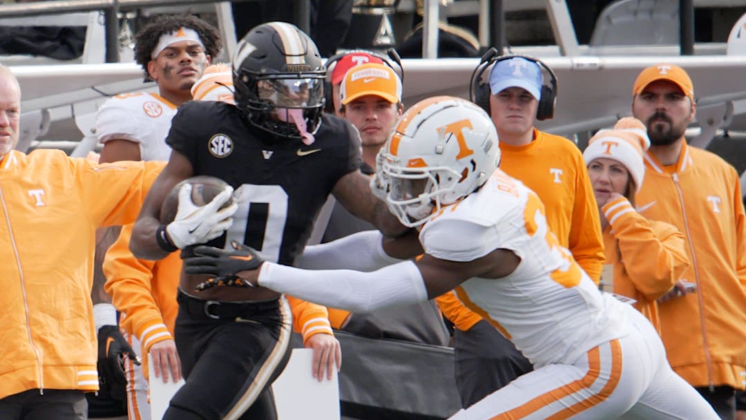 Vanderbilt wide receiver Junior Sherrill (0) stiff arms Tennessee defensive back Montrell Bandy (37) during the third quarter at FirstBank Stadium in Nashville, Tenn., Saturday, Nov. 30, 2024.