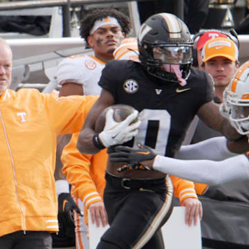 Vanderbilt wide receiver Junior Sherrill (0) stiff arms Tennessee defensive back Montrell Bandy (37) during the third quarter at FirstBank Stadium in Nashville, Tenn., Saturday, Nov. 30, 2024.