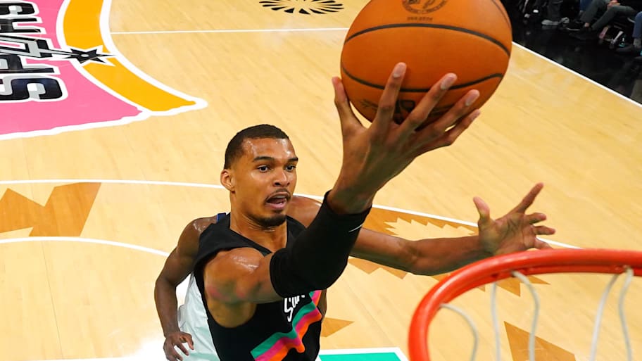 San Antonio Spurs forward Victor Wembanyama lays in a basket against the Dallas Mavericks.
