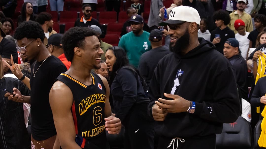 Mar 28, 2023; Houston, TX, USA; West guard Bronny James (6) with father LeBron James following the McDonald's All American Boy's high school basketball game at Toyota Center. Mandatory Credit: Mark J. Rebilas-USA TODAY Sports