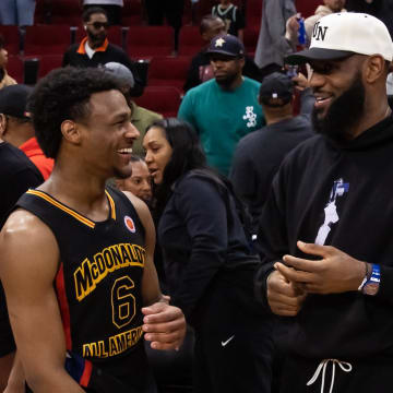 Mar 28, 2023; Houston, TX, USA; West guard Bronny James (6) with father LeBron James following the McDonald's All American Boy's high school basketball game at Toyota Center. Mandatory Credit: Mark J. Rebilas-USA TODAY Sports