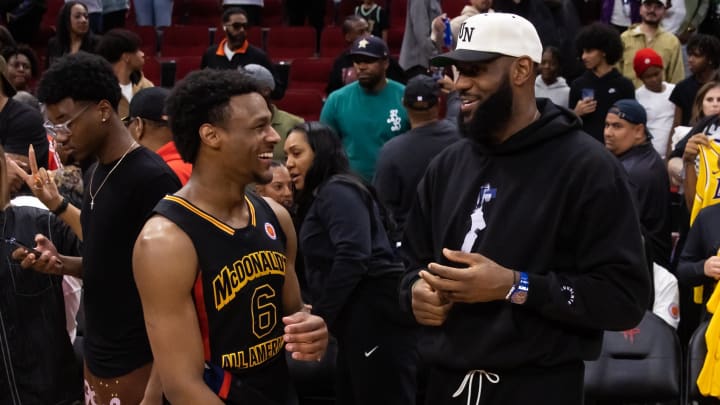 Mar 28, 2023; Houston, TX, USA; West guard Bronny James (6) with father LeBron James following the McDonald's All American Boy's high school basketball game at Toyota Center. Mandatory Credit: Mark J. Rebilas-USA TODAY Sports