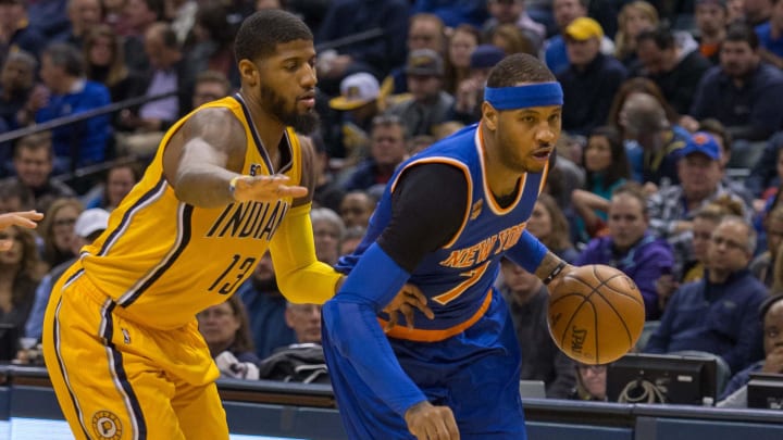 Jan 7, 2017; Indianapolis, IN, USA;  New York Knicks forward Carmelo Anthony (7) dribbles the ball while Indiana Pacers forward Paul George (13) defends in the second quarter of the game at Bankers Life Fieldhouse. Mandatory Credit: Trevor Ruszkowski-USA TODAY Sports