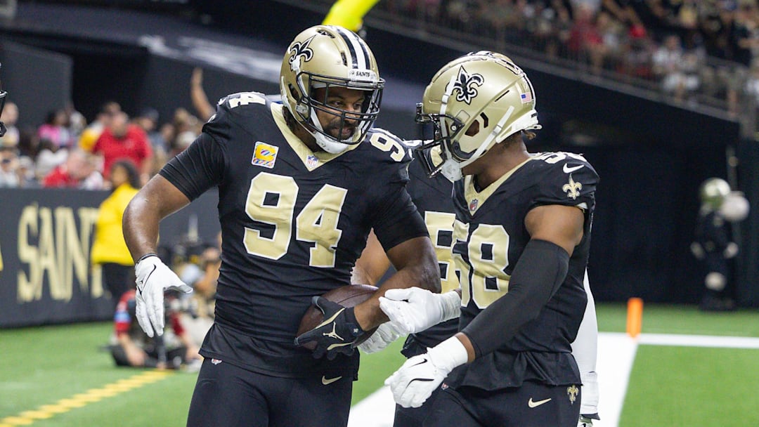 Oct 13, 2024; New Orleans, Louisiana, USA;  New Orleans Saints defensive end Cameron Jordan (94) reacts to intercepting the pass of Tampa Bay Buccaneers quarterback Baker Mayfield (6) during the first half at Caesars Superdome. Mandatory Credit: Stephen Lew-Imagn Images