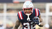 Nov 2, 2025; Foxborough, Massachusetts, USA;  New England Patriots running back TreVeyon Henderson (32) runs the ball against the Atlanta Falcons during the third quarter at Gillette Stadium. Mandatory Credit: Brian Fluharty-Imagn Images