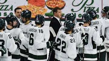 MSU hockey coach Adam Nightingale and his Spartans gather on the ice following MSU's 4-3 win over Notre Dame, Saturday, Nov. 15, 2024.