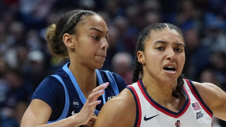 UConn Huskies guard Azzi Fudd drives the ball against Villanova Wildcats guard Kennedy Henry. UConn Huskies guard Azzi Fudd drives the ball against Villanova Wildcats guard Kennedy Henry.
