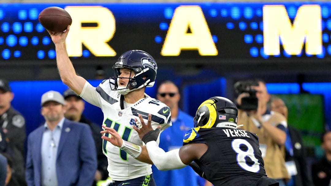 Nov 16, 2025; Inglewood, California, USA;  Seattle Seahawks quarterback Sam Darnold (14) is pressured by Los Angeles Rams linebacker Jared Verse (8) at SoFi Stadium. Mandatory Credit: Jayne Kamin-Oncea-Imagn Images