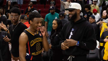 Mar 28, 2023; Houston, TX, USA; West guard Bronny James (6) with father LeBron James following the